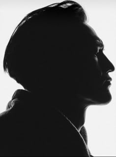 a black and white photo of a man's profile with his head turned to the side