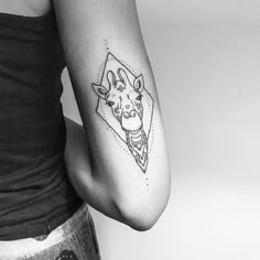 a giraffe tattoo on the left arm and shoulder is shown in black and white