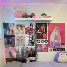 there is a bed in the room with pictures on the wall and lights above it