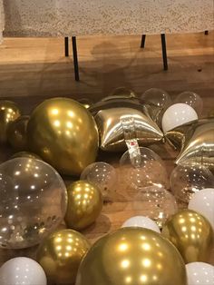 shiny gold and white balloons are on display