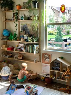 two children are playing with toys in the living room while another child sits on the floor