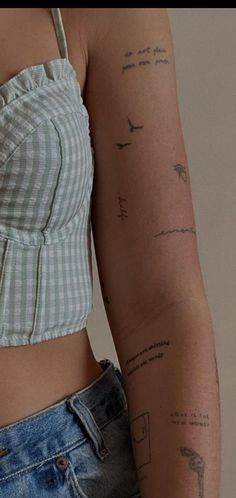 a woman's arm with tattoos on it