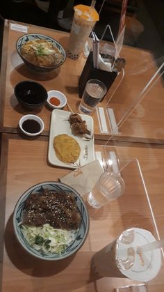 a table topped with plates and bowls of food