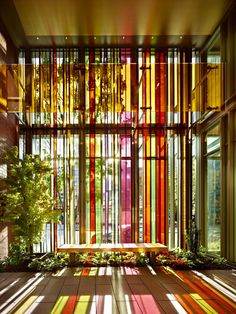 the inside of a building with lots of windows and colorful blinds on it's walls