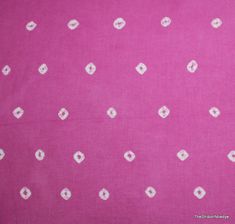 a pink background with white squares and dots