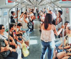 many people are sitting on the subway train