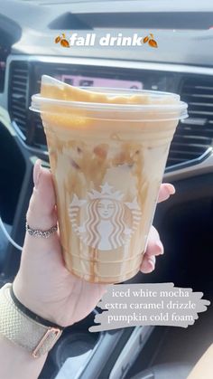 a woman holding up a starbucks drink in her hand with the caption fall drink iced white mocha extra caramel drizzle pumpkin cold coffee