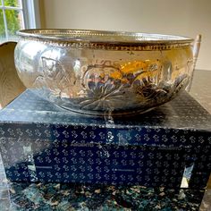 a silver bowl sitting on top of a blue box