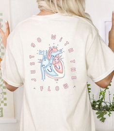 the back of a woman's t - shirt with an image of a heart on it