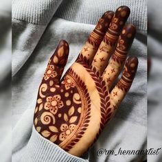 a person's hand painted with hendi designs on their fingers and hands,