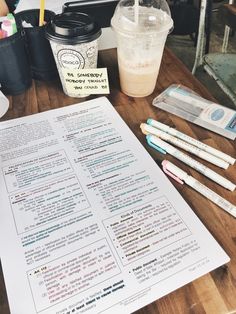 a table topped with lots of writing supplies