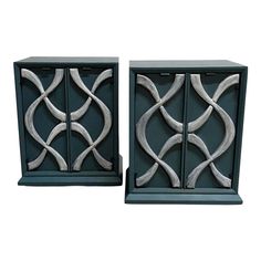 a pair of metal boxes with decorative designs on the front and back, both in grey