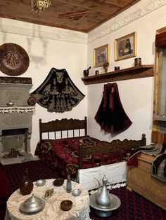 a bed room with a neatly made bed next to a fire place