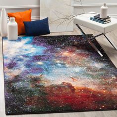 an area rug with colorful stars on it in the middle of a room next to two vases