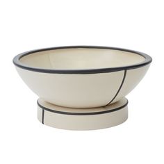 a white bowl with black trim around the rim