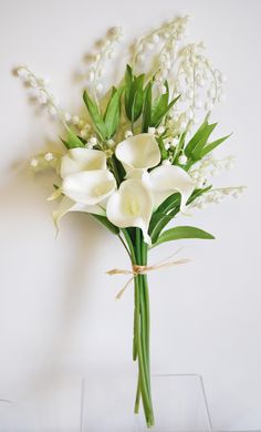 a bouquet of white flowers in a clear vase