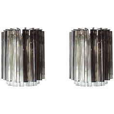 a pair of glass and chrome wall lights