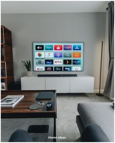 a flat screen tv sitting on top of a white entertainment center