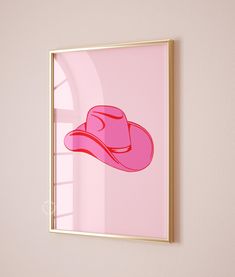 a pink cowboy hat hanging on the wall