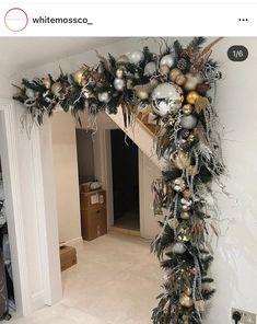 an arch decorated with christmas ornaments in gold, silver and white colors is featured on the instagram page