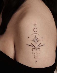 a woman's shoulder with a star and moon tattoo on her left side ribcage