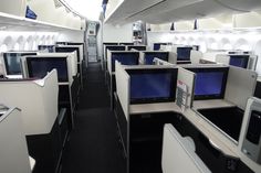 the inside of an airplane with many computers and monitors on each side of the seats