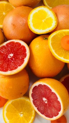 oranges and grapefruits cut in half on a white plate