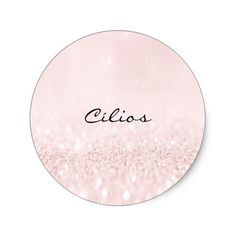 a round sticker with the word cilos written in black ink on pink glitter