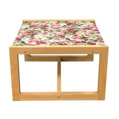 a small wooden table with pink and purple flowers on it's top, against a white background