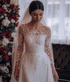 a woman wearing a wedding dress and veil