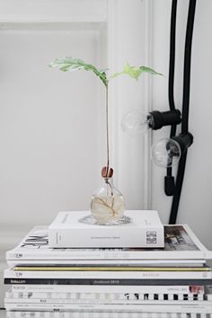 a stack of books sitting on top of each other in front of a white door