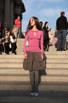 a woman standing in front of some steps