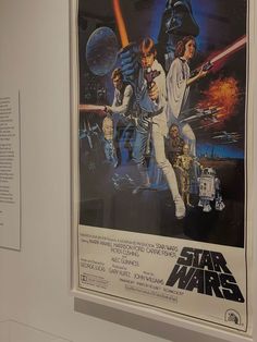 a star wars movie poster hanging on the wall