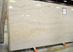 a large white marble slab is being displayed in a store with other items on the floor