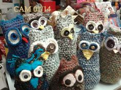 several crocheted owls sitting on top of a table next to each other in different colors