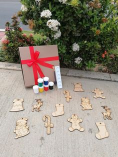 a box that has some wooden cutouts in front of it with paint and glue