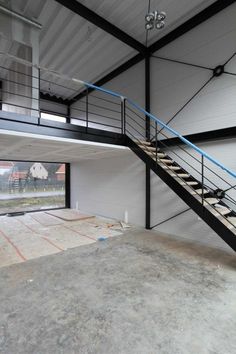 the inside of a building with stairs and windows