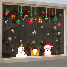 a window decorated with christmas decorations and snowmen