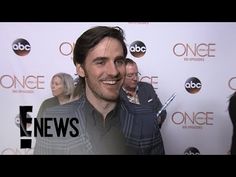 a man standing in front of a red carpet