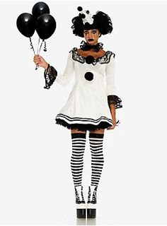 a woman dressed in black and white is holding some balloons while wearing tights and stockings