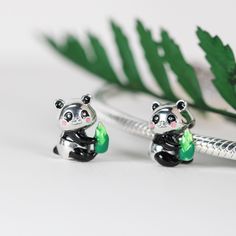 This is charm only, bracelet is sold separately. Add a touch of adorability to your bracelet with this charming 925 sterling silver Panda with bamboo shoot bead charm from The Silver Luna. The charm features a detailed design of a cute Panda holding onto a bamboo shoot, making it perfect for the animal or anime lover in your life. The charm is made of high-quality silver with a metal purity of 925, ensuring its durability and longevity. Additionally, this charm has a versatile style that allows it to fit seamlessly into any charm bracelet. Whether you're looking for a gift for a loved one or adding to your charm collection, this Silver Luna charm is a fantastic choice. Dimensions: 0.40 x 0.36 in  Charm holes: 0.18 in Materials: 925 sterling silver Finish: platinum plate, enamel Panda With Bamboo, Bamboo Shoot, Panda Charm, Peaceful Nature, Bamboo Shoots, Detailed Design, Silver Charm Bracelet, Cute Panda, Pandora Bracelet