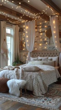 a bedroom decorated in white with fairy lights