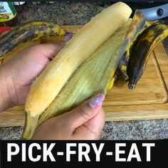 a person holding a banana on top of a cutting board