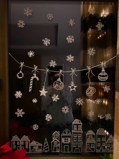 a window decorated with snowflakes and christmas decorations