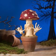 a mushroom sitting on top of a potted plant