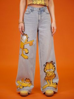 Get cat walk ready with these Garfield denim pants! They have a light wash and wide leg silhouette. Bursting with cat-titude  these pants feature Garfield printed on the legs in various poses. Comes with classic 5-pocket styling. Garfield Pjs, Orange Clothes Aesthetic, Garfield Clothes, Garfield Outfit, Christmas Lights Outfit, Garfield Merch, Garfield Aesthetic, Tiktok Aesthetics, Garfield Costume