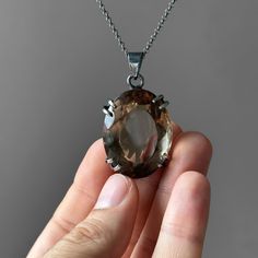 Smoky Quartz Pendant - Large Smoky Quartz Necklace - Quartz Pendant - Smoky Quartz Jewelry - Quartz - Sterling Silver and Smoky Quartz Gemstone: Natural Smoky Quartz Metal: 925 Sterling Silver Stone Cut: Faced Stone Size: 36 mm x 28.2 mm - 1.41 in x 1.11 in Pendant Size: 51 mm x 28.2 mm - 2.01 in x 1.11 in Weight: 27 grams (135 carats ) total weight of stone and metal.  For ring orders, ring resizing is free.  Chains are gifts for necklace orders..  Note: We don't use any filters for photos. The details may not be clear. Feel free to contact us with any questions, special orders or additional photo or video requests. We will be happy to provide more information! :) WORLDWIDE FedEx, UPS or TNT EXPRESS MAIL SERVICE (Delivery time: 1 - 5 business days.) LAYAWAY PAYMENT PLAN is available. ABOU Smoky Quartz Jewelry, Oxidized Silver Necklace, Smoky Quartz Necklace, Smoky Quartz Pendant, Quartz Jewelry, Payment Plan, Oxidized Silver, Quartz Pendant, Quartz Necklace