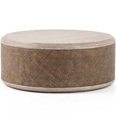 a round wooden table sitting on top of a white floor