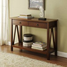 a wooden table with two drawers and a shelf underneath it on a carpeted floor