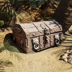 an old trunk sitting in the sand next to a tree